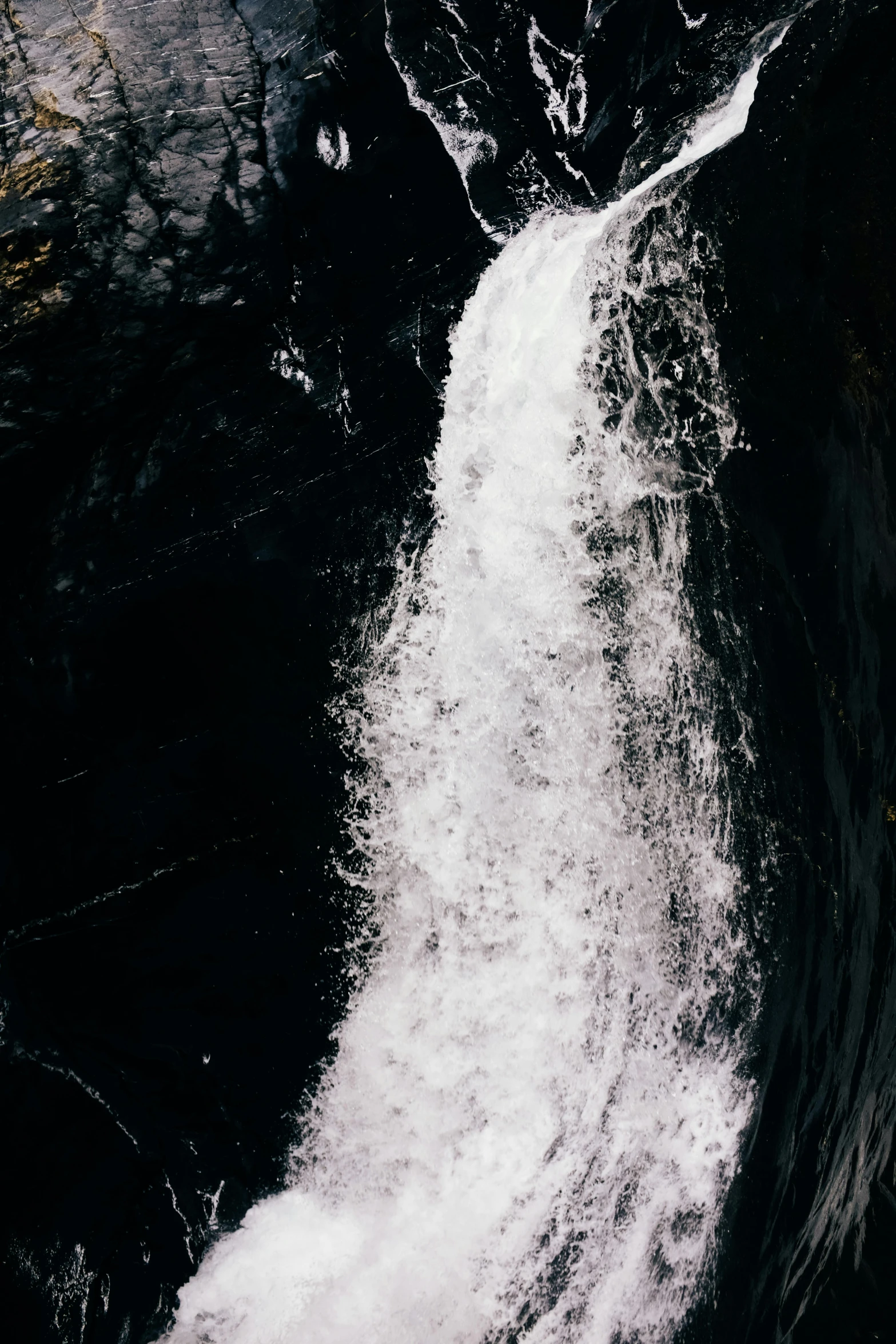 the water is rushing against the rocks next to the shore