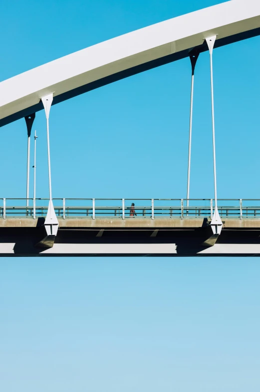 a bridge has a man riding his bike across it