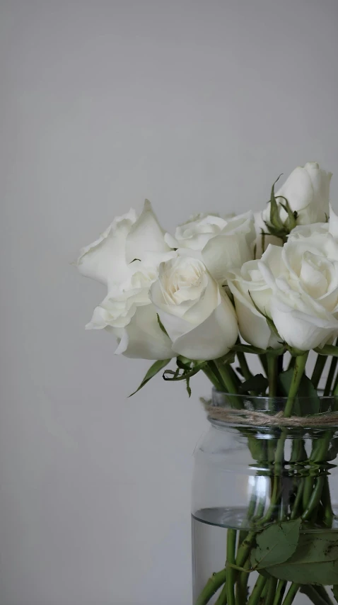 a bouquet of flowers is in a glass jar