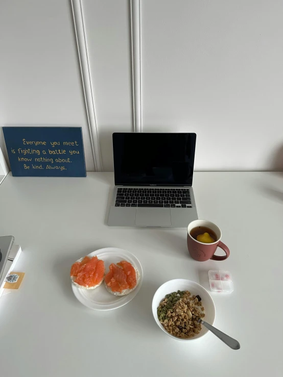 there are some food and drinks next to an open laptop