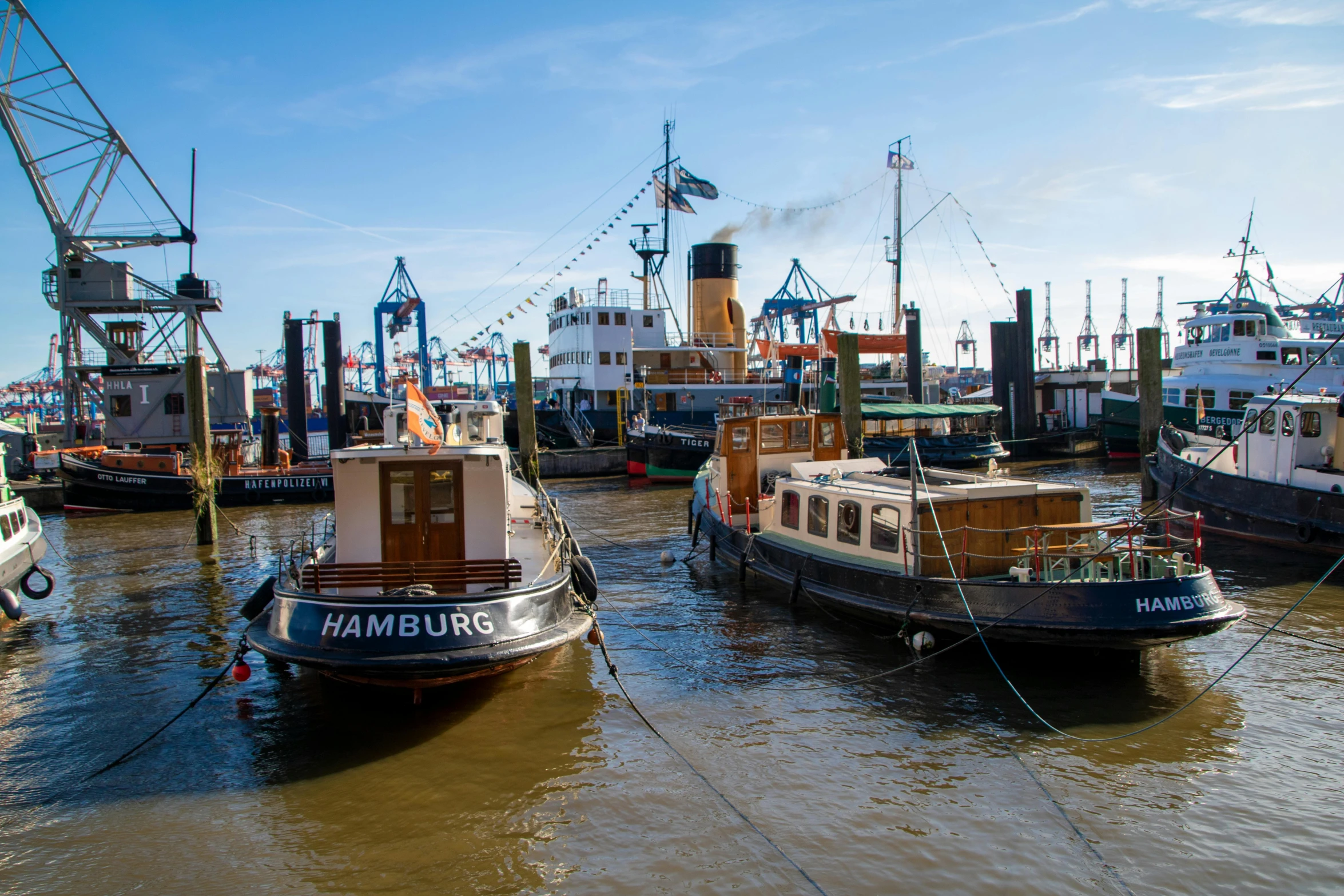 a group of large boats tied up in the water