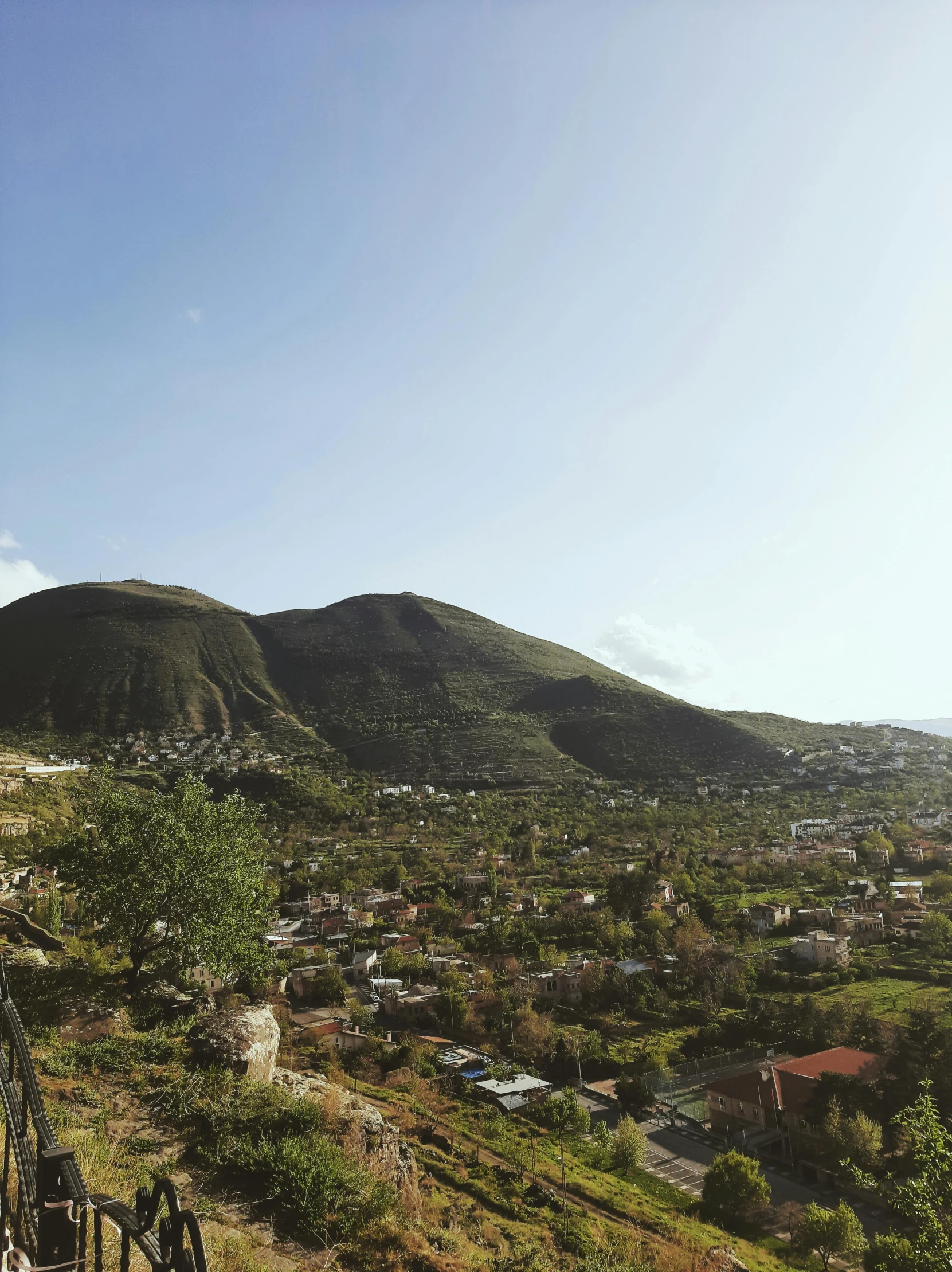 a scenic view of a mountain town on the coast