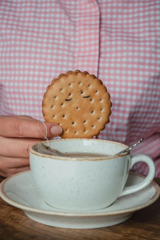 a person eating a er out of a teacup