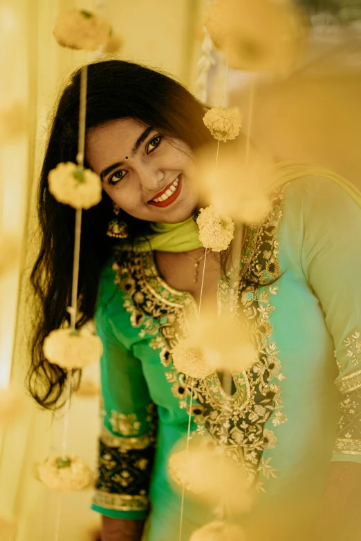 a woman standing in front of flower decorations