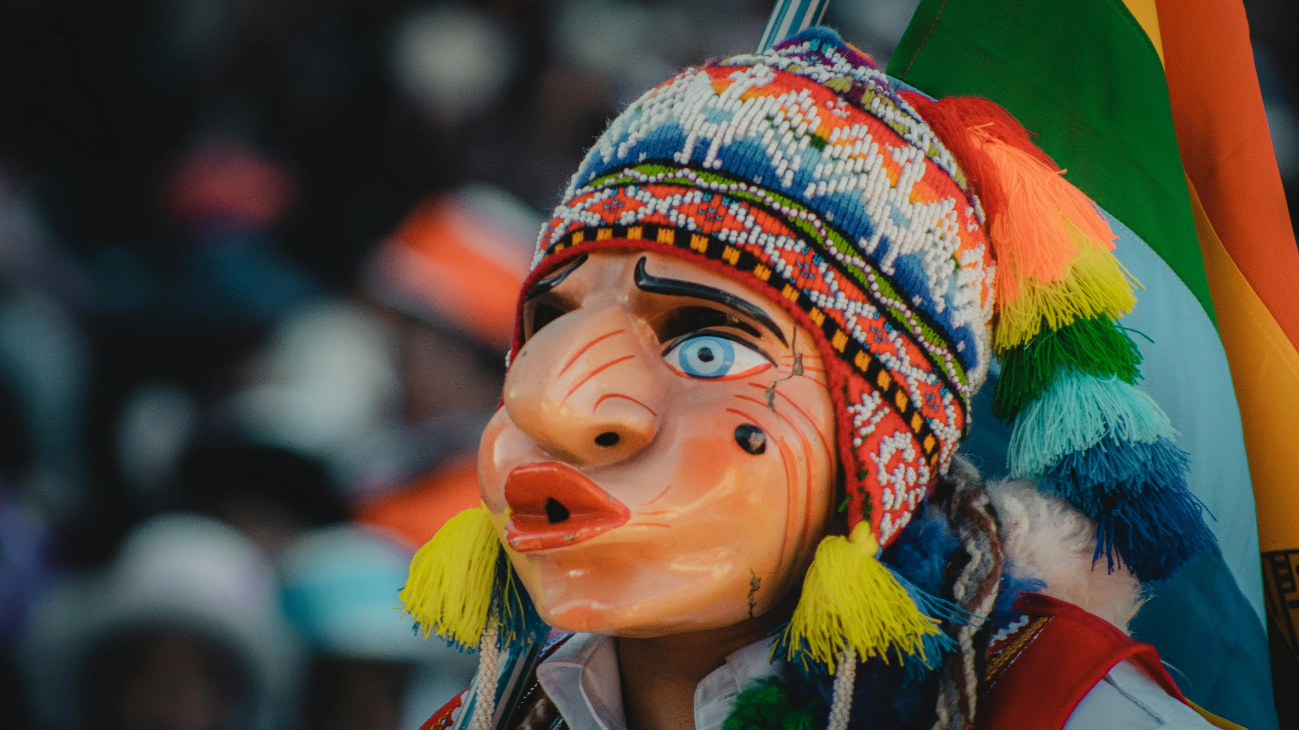 a close up of a painted head and some flags