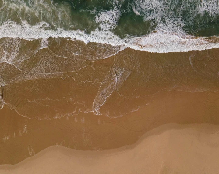 there is a beach with waves in the water