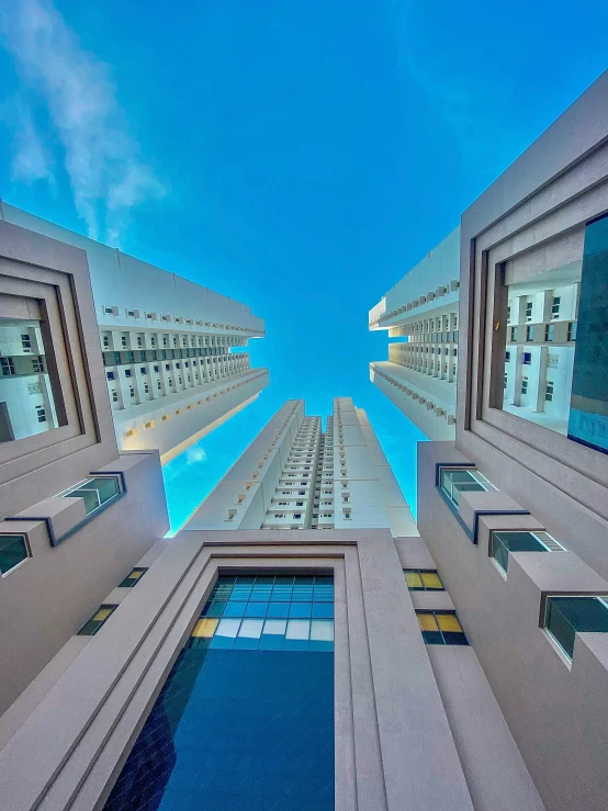 a view of a very tall building, reflecting the sky