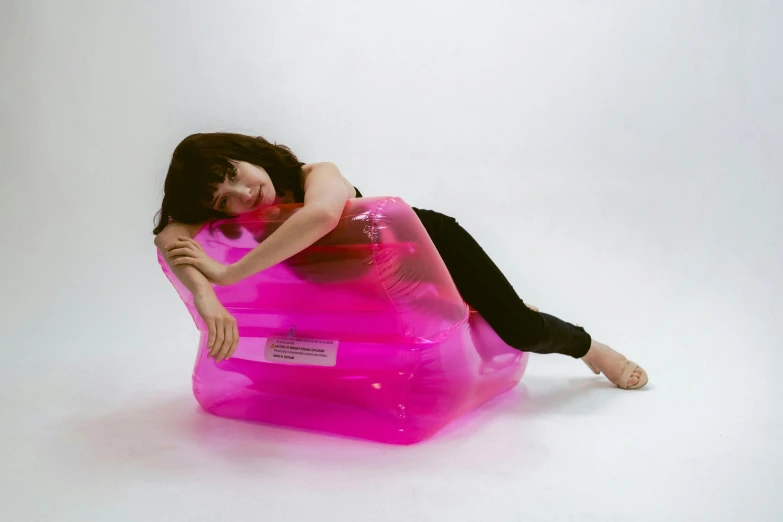 a woman laying on top of an inflatable chair