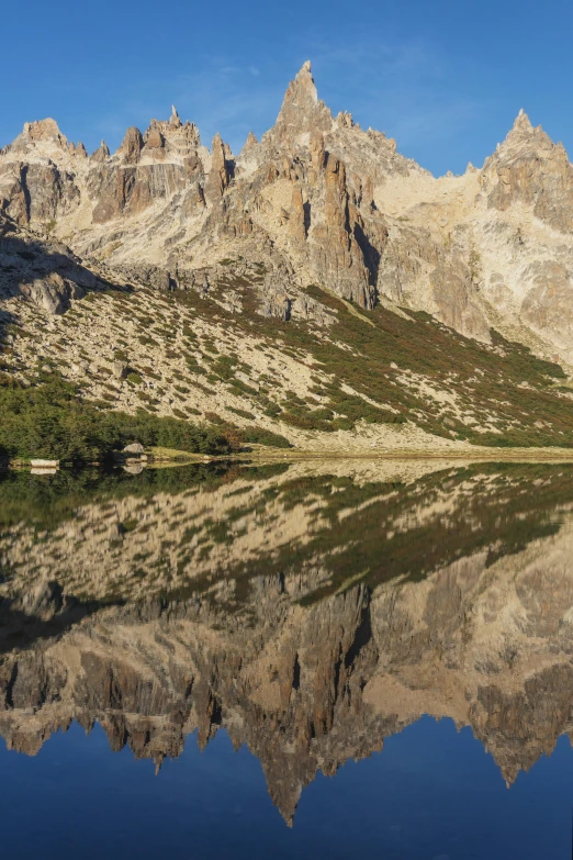 a small mountain sitting over a large lake