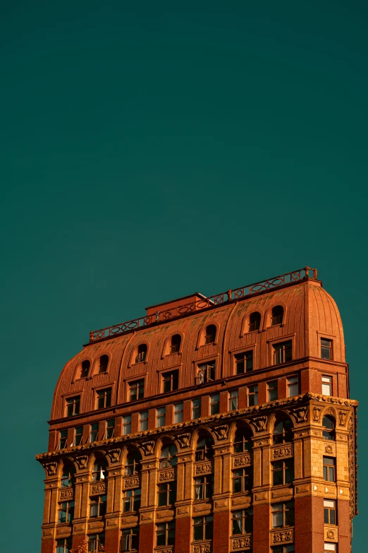 the top of a tall building under a blue sky