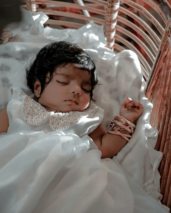 a baby sleeping in a small basket