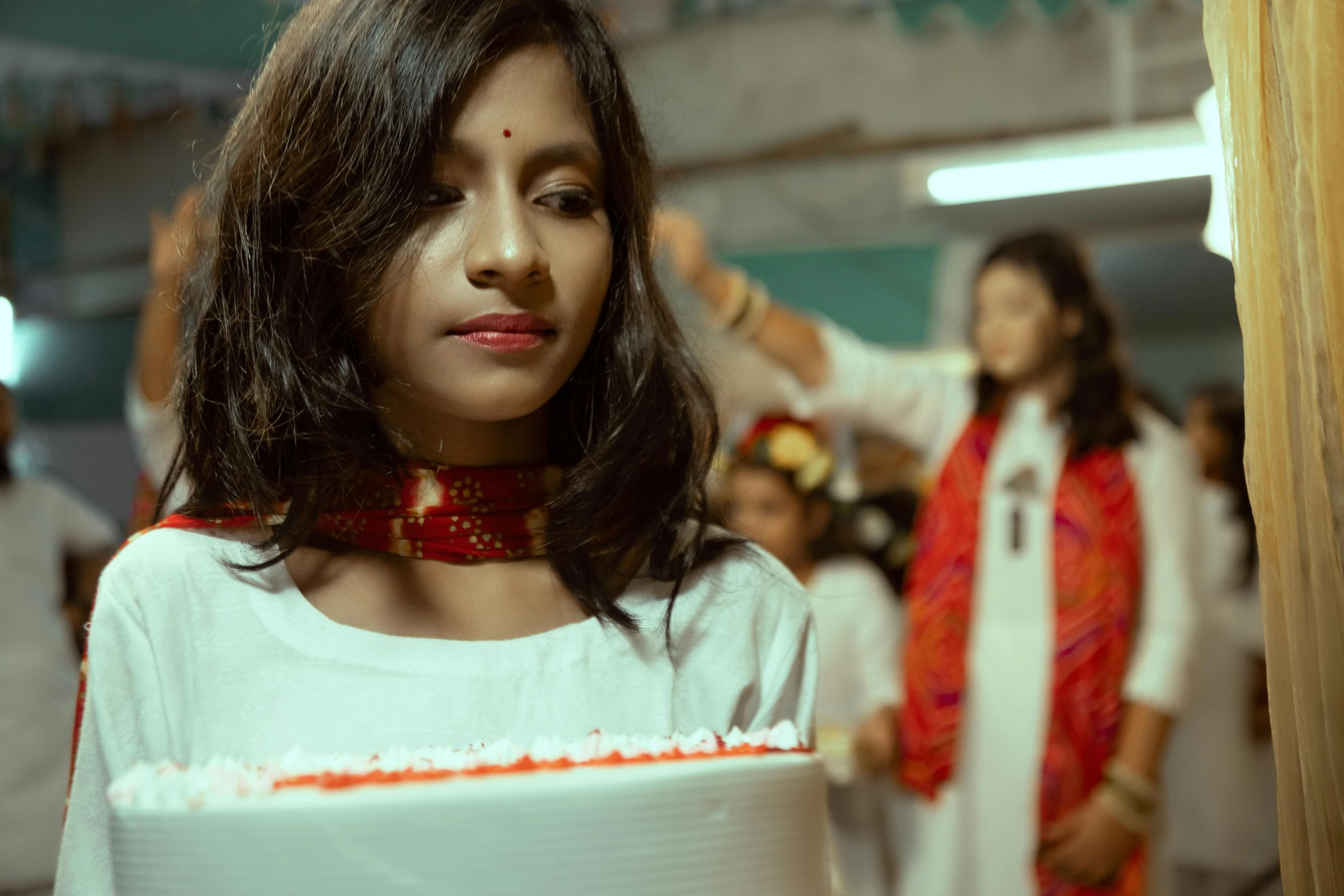 a woman wearing a choket stands in front of her group of people