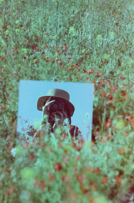 a man in a green hat taking a po of himself