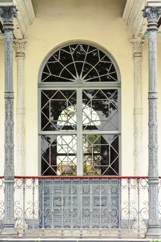 the metal balcony is adorned with intricate design