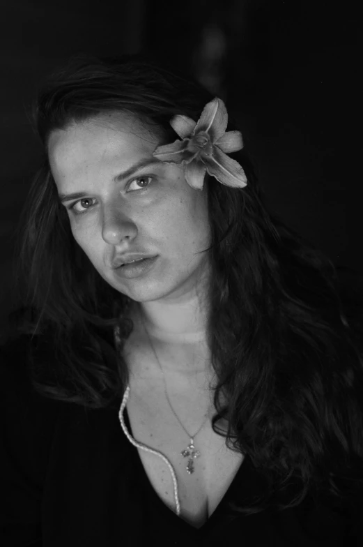 black and white po of a woman with a flower in her hair