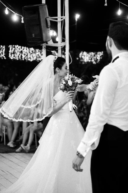 a bride and groom holding hands at their wedding