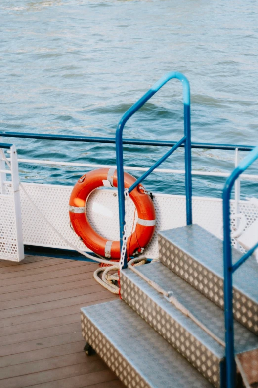 a life preserver is tied on a deck next to stairs