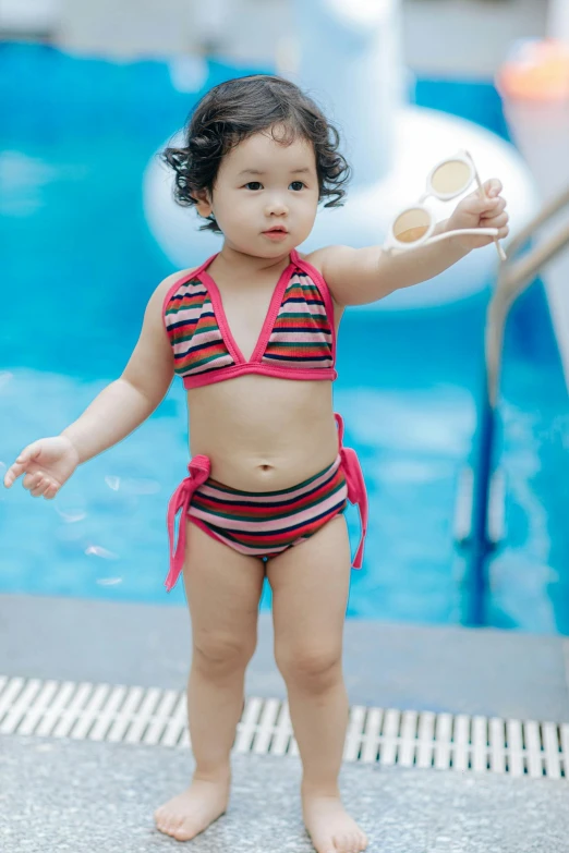 a  in a red bikini holding a paddle