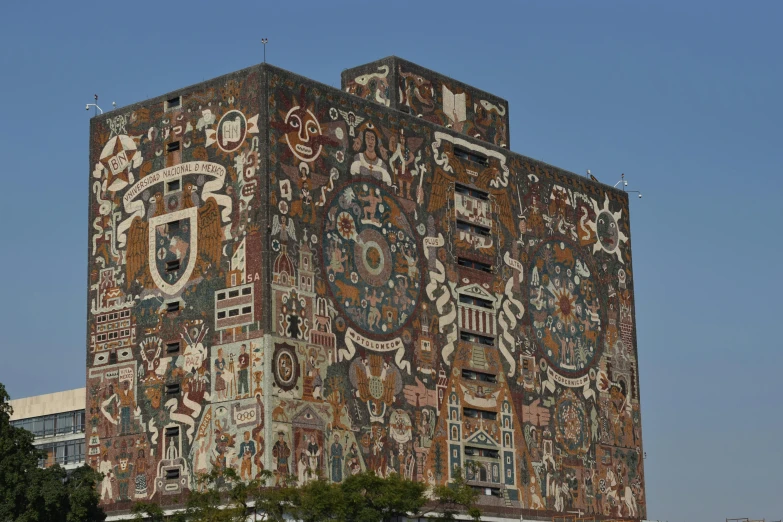 the side of a building that is covered in pictures