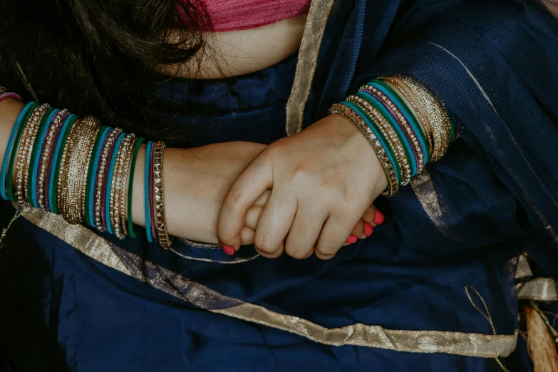 woman wearing bangies and a celets with different colors