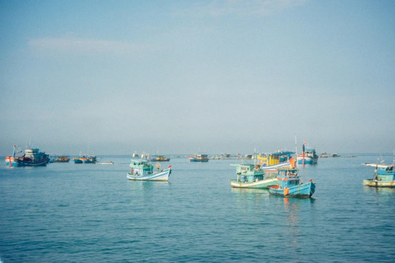 a group of boats floating in the ocean