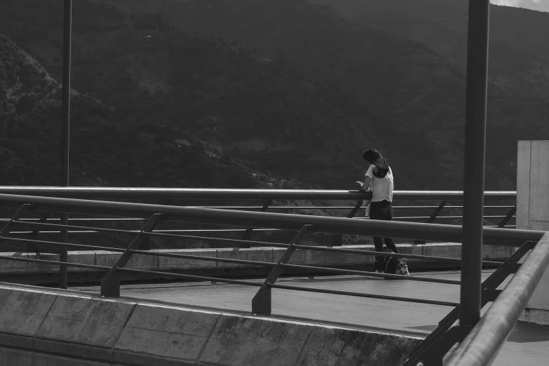 two boys skateboard on the top of a cement ramp