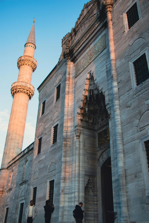 two people walking towards an old building