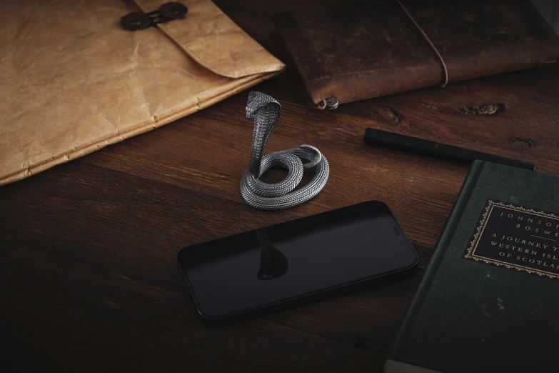 some books, a phone, and a wallet on a table