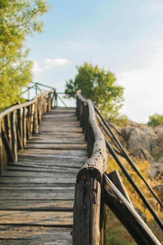 a old wooden bridge with iron bars and rails