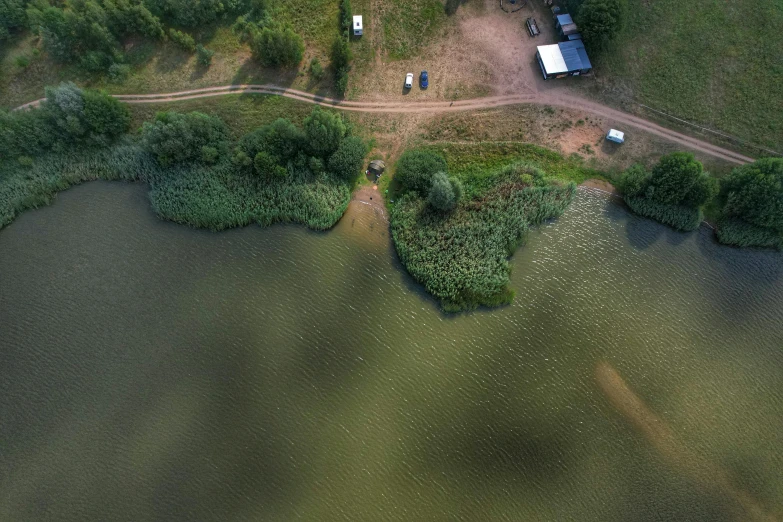 the view from above of a lake with trees