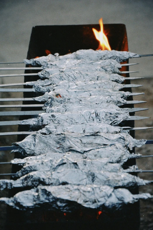 a charcoal fire grill that is over a lot of rocks