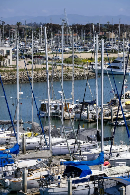 a small harbor with many boats and large yachts