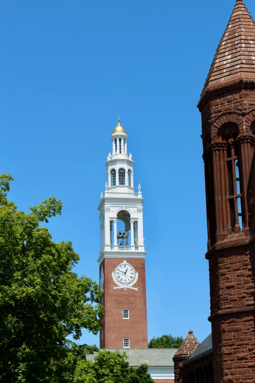 a large tall clock tower under a blue sky