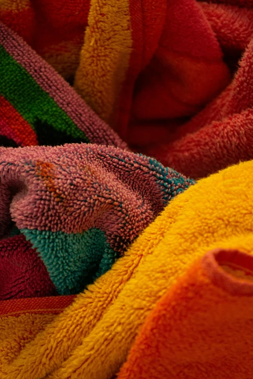 many colorful towels folded and laying together