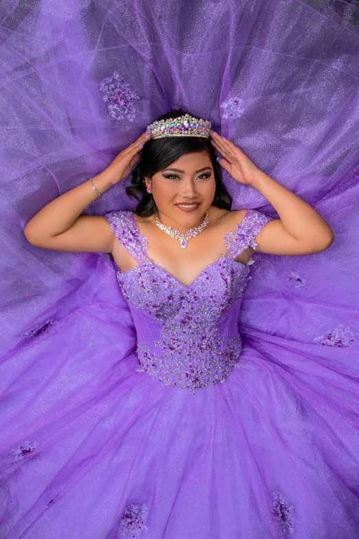 a woman with purple dress and tiara