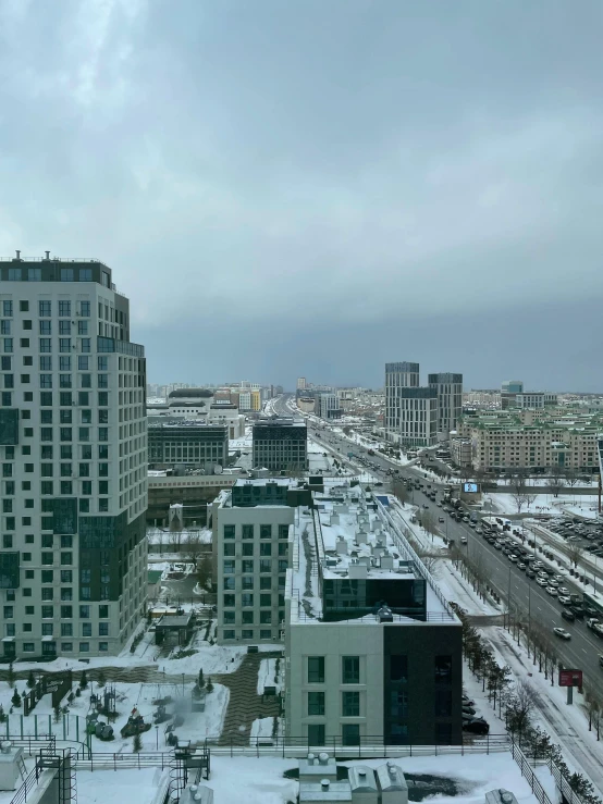 a city view covered with snow and a cloudy sky