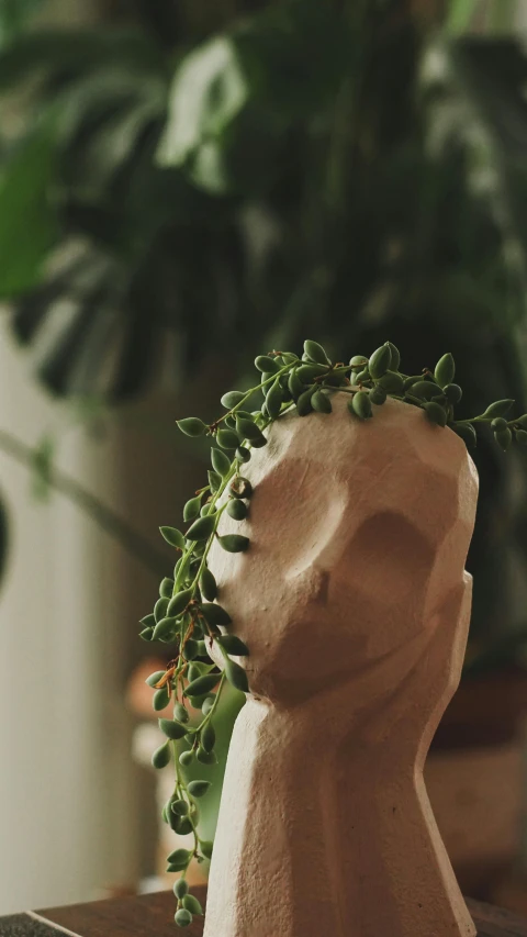a close up of a figurine wearing a head plant