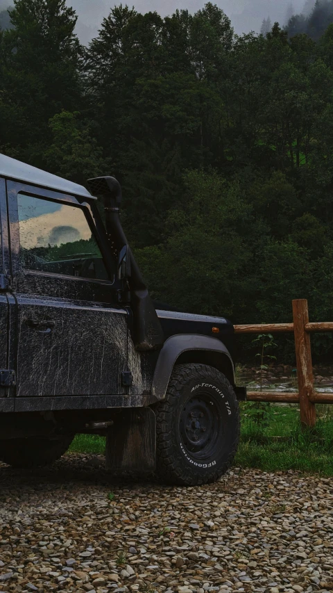 a dirty truck sitting on top of a gravel road