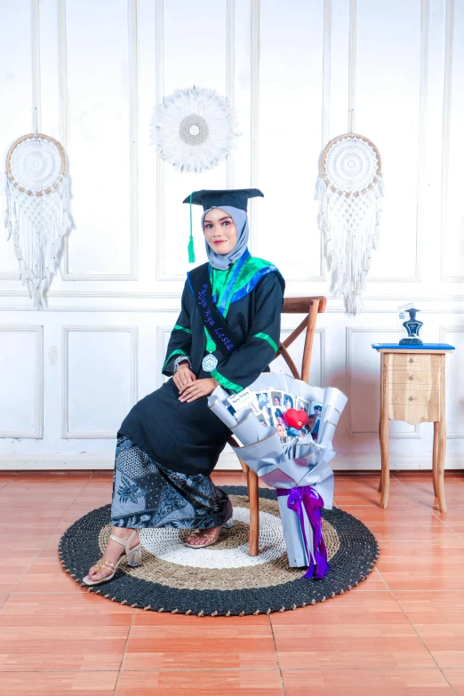 the girl is sitting on her chair in her graduation gown