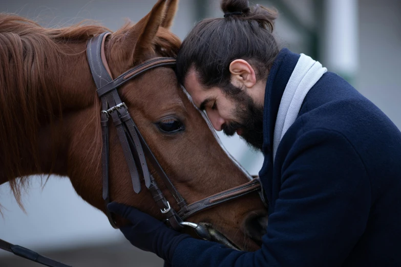 a man hugging his horse in the face