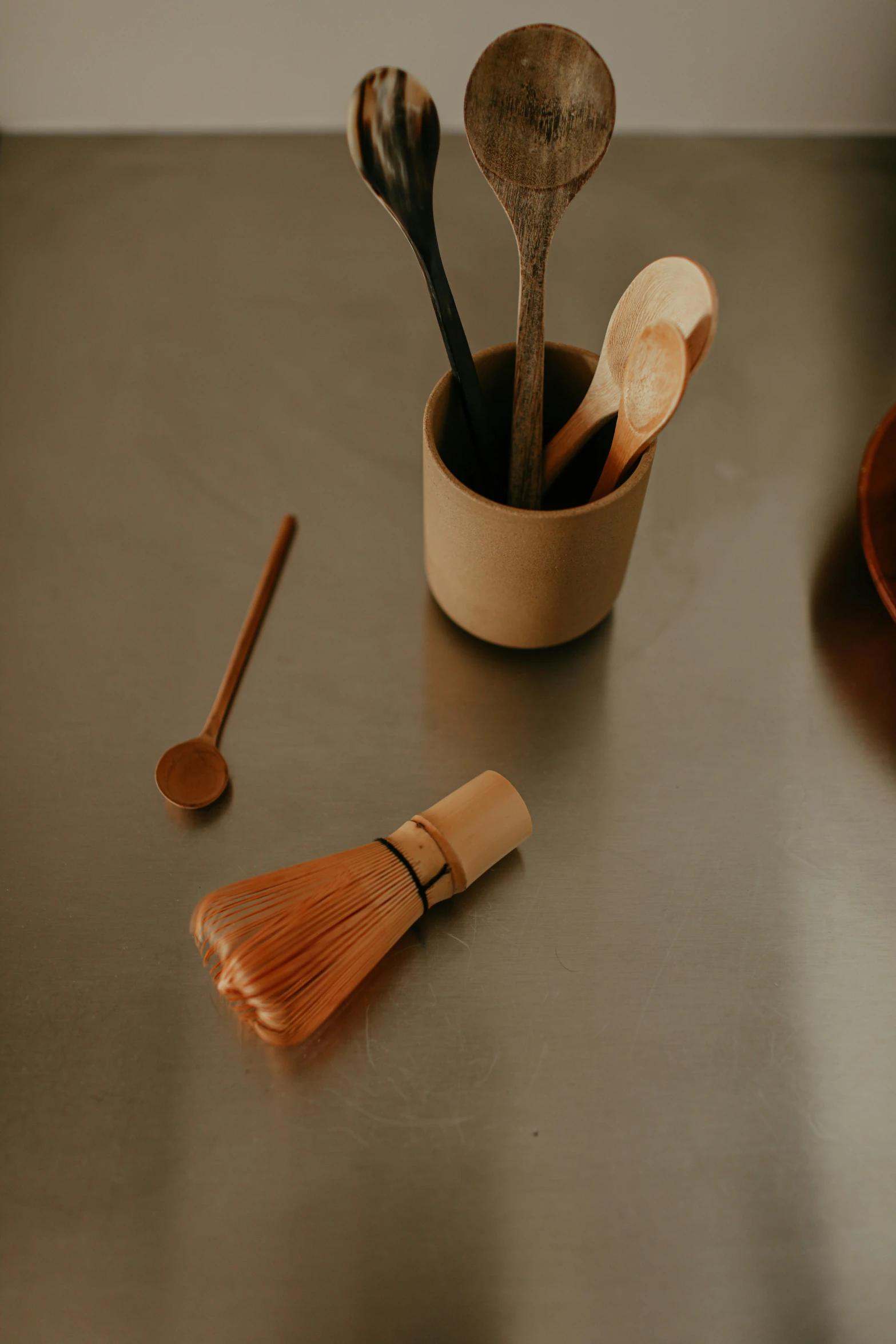 wooden utensils are placed on a table in pots