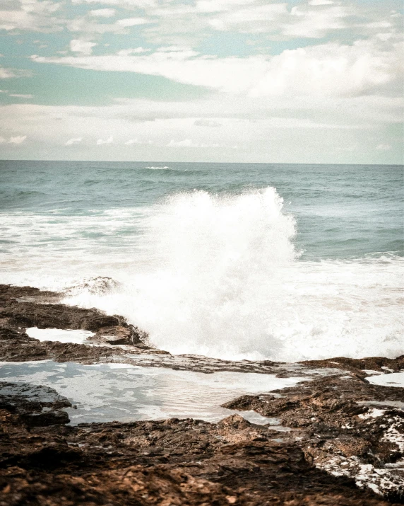 a person riding a surfboard next to a body of water