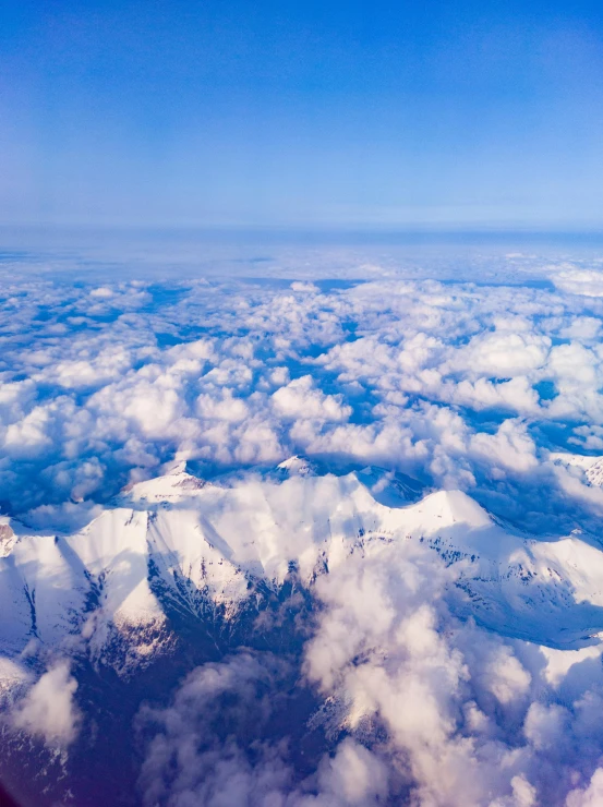 a large amount of clouds over some mountains