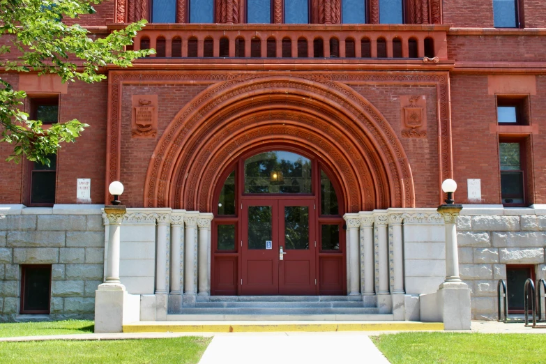 a building with large red doors and pillars