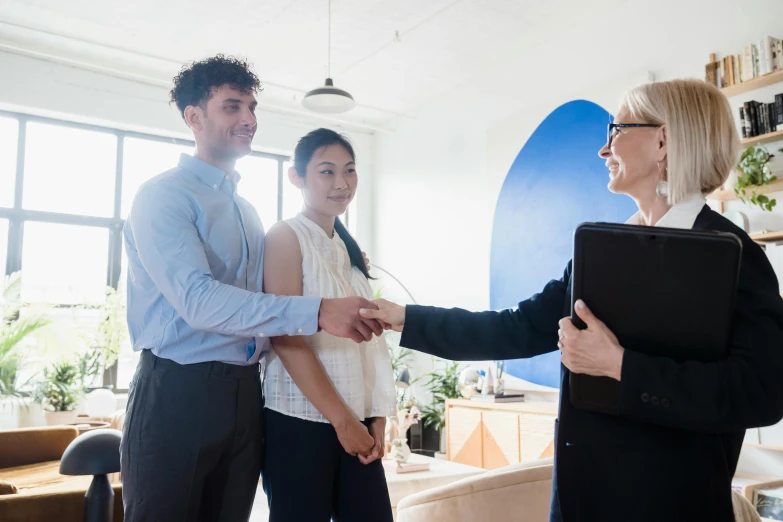 a group of people shaking hands in an office