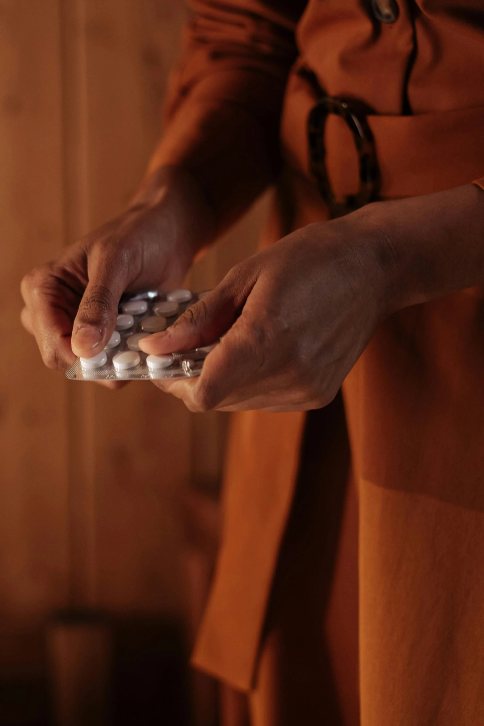 a woman holding several pills in her hands