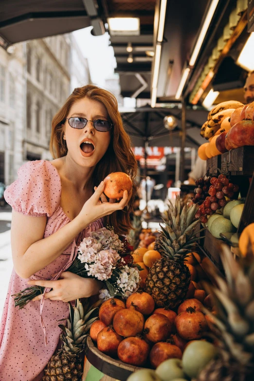 a woman in sunglasses at a fruit stand