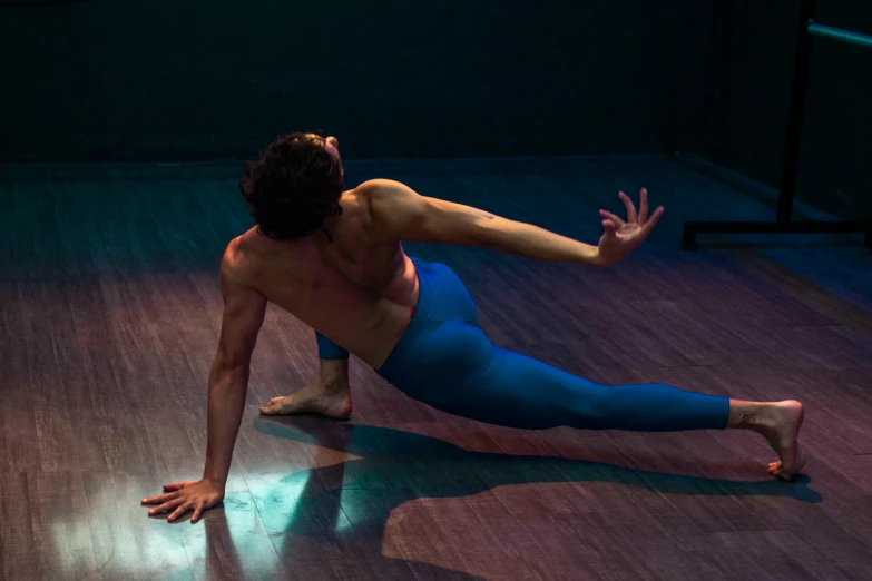 a man performing yoga exercises with one leg extended