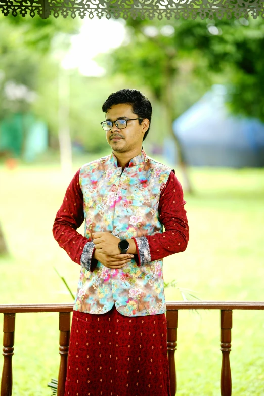 the man is wearing an asian - style shirt with flower print