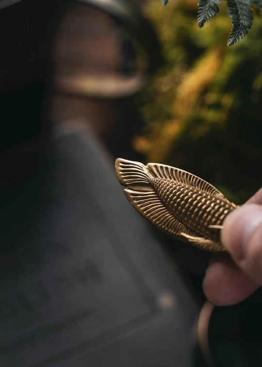 a person holding up some small gold objects